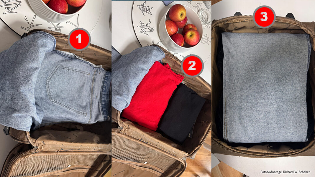 Hose wird one Falten in Koffer gepackt, in drei Schritten. 1. Jeans mit Bund-Seite herein legen, Hosenbeine hängen heraus. 2. Gefaltete Hemden und Shirts drauf. 3. Wäsche in Hosenbeine einschlagen.
